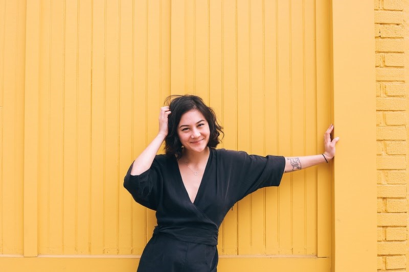 Japanese Breakfast leaning against a wall